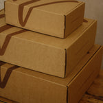 Stack of cardboard boxes on a wooden surface