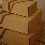Stack of cardboard boxes on a wooden surface