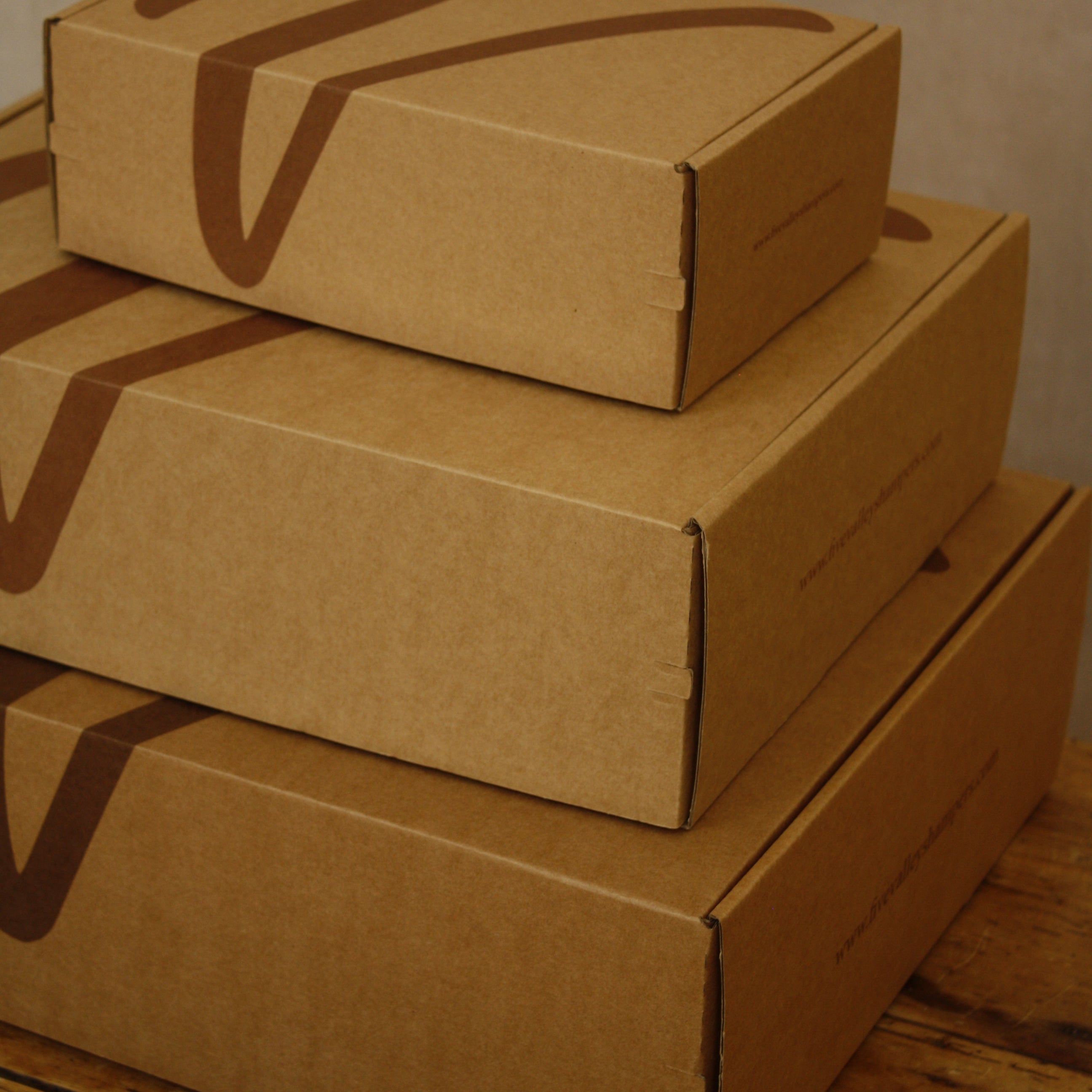 Stack of cardboard boxes on a wooden surface