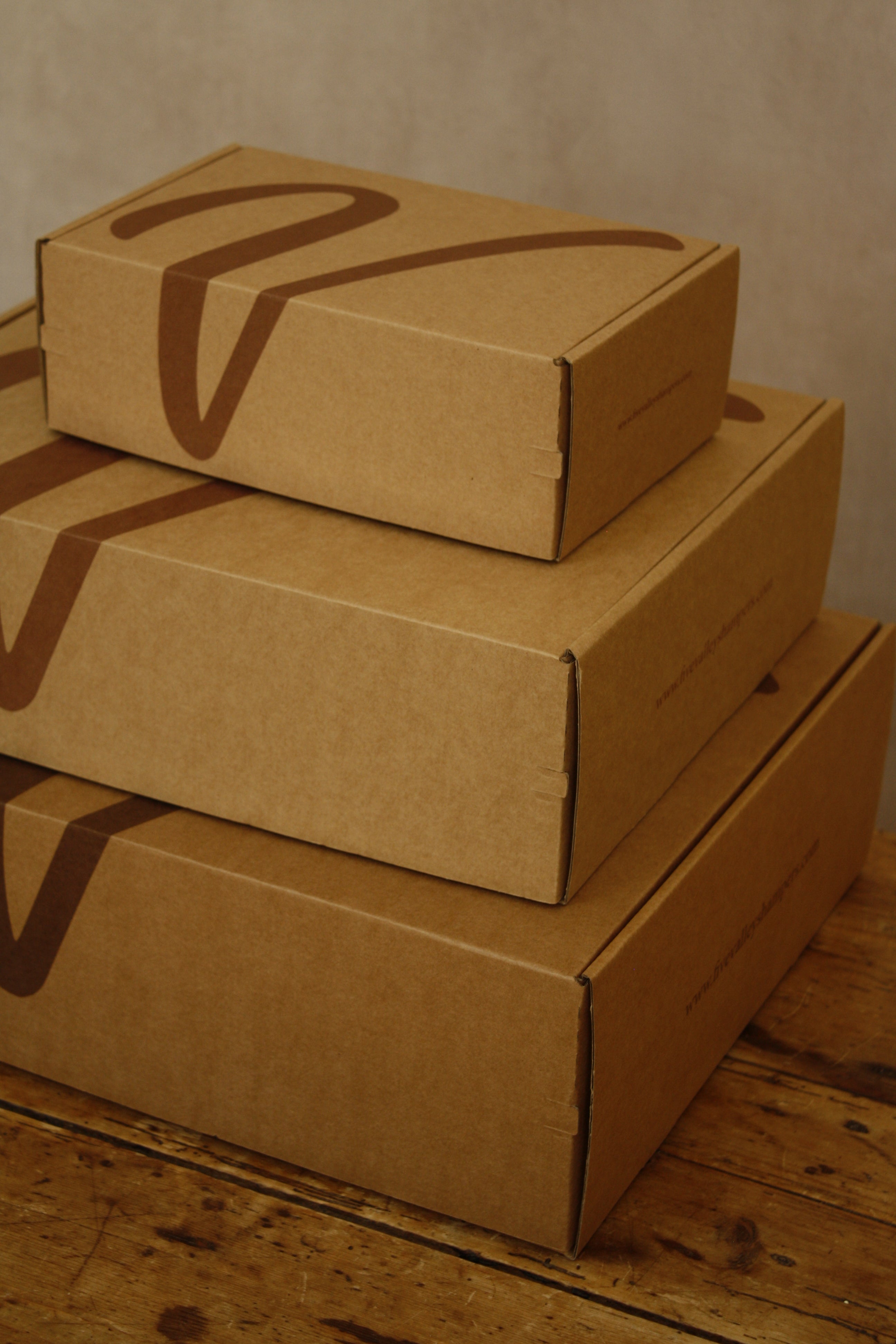 Stack of cardboard boxes on a wooden surface