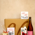Collection of products including a bottle, box, and packages on a beige background